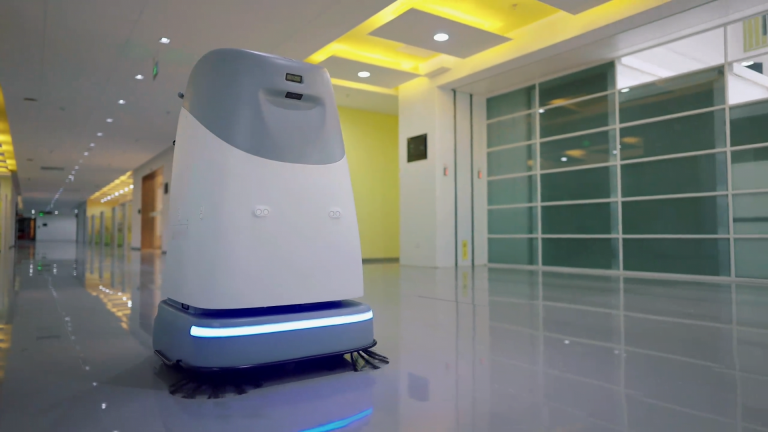 Quad 800 autonomous industrial robot floor scrubber cleaning a high-traffic public venue floor